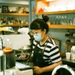 woman in black and white stripe shirt sitting on chair